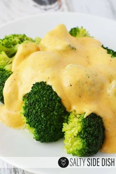 broccoli and cheese sauce on a white plate