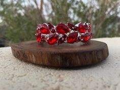 "Beautiful bracelet with red rhinestone crystals, great statement piece! Pageant, prom, or bridal!  Size: .75\" wide  Length: 7.5 inches (length can be sized to custom fit) Style: stretch bracelet color: red crystals / silver base metal red/ gold base metal Bracelet comes in individual gift box, and thank you card and ribbon can be added free of charge, just leave a comment at checkout :)  Looking for matching earrings or necklace? Browse through our listings or send us a message! :)  https://www.etsy.com/listing/507893090/red-rhinestone-earrings-large-crystal?ref=shop_home_active_3 https://www.etsy.com/listing/595623975/ https://www.etsy.com/listing/1573439148/ Looking for the perfect pair of earrings for a special occasion. We specialize in custom work in fashion jewelry, pearls, and nat Prom Bracelet, Red Bracelet, Fun Ornaments, Metal Bracelet, Red Prom, Red Bracelets, Red Rhinestone, Rhinestone Bracelet, Red Crystals