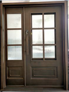 the front door is brown and has two glass panels on it, along with a sidelight