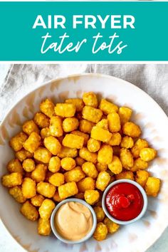 air fryer tater tots on a plate with ketchup and mustard