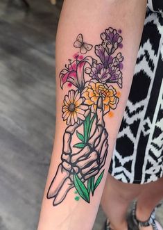 a woman's arm with flowers on it