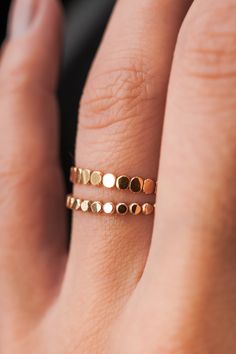 This stacking ring is perfect for mixing and matching! Either wear several at once or mix some in with your favorite rings for extra width and sparkle! This new version of the Bead Ring is slightly more durable than its predecessor! This listing is for ONE SINGLE ring.This ring is made out of 14K GOLD FILL metal.The finish is lightly faceted/hammered.* The photos show this new Mini Bead Ring style compared to our Original Bead Ring! Each Mini Bead Ring is individually cut, soldered and polished Stackable 14k Gold Midi Rings With Open Band, 14k Gold Stackable Toe Rings, 14k Gold-filled Stackable Midi Rings With Open Shape, 14k Gold Filled Stackable Midi Open Rings, Stackable Midi Open Rings In 14k Gold Filled, Stackable Rose Gold Midi Rings With Open Band, Stackable Rose Gold Open Band Midi Rings, Rose Gold Stackable Midi Rings With Open Band, Adjustable Gold Rings For Layering