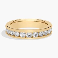 a yellow gold wedding ring with five stones on the side and two rows of diamonds in each