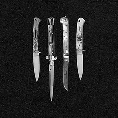 five knives are lined up in a row on a black background, with one knife pointed at the camera