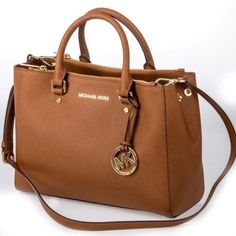 Michael Kors Handbag Large With A Lot Of Space Inside Has Short Straps As Well As A Detachable Crossbody Strap Color Is Cognac Or A Tan Has Lots Of Different Compartments Inside Including Small And Large Zip Compartments Only Sign Of Wear Is On The Feet And On The Bottom As Shown Michael Kors Bedford, Tan Handbags, Michael Kors Satchel, Mk Handbags, Tan Bag, Cheap Michael Kors, Bags Michael Kors, Michael Kors Outlet, Mk Bags