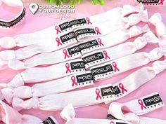 "These breast cancer  custom wristbands hair ties are the great  for fundraising events or for breast cancer awareness campaings. Shop Now! They are multipurpose, can be used as a bracelet on your wrist and as hair ties to hold your hair back. no crease or damage. Unisex wristbands. *CUSTOMIZATION* We can customize them with your compat logo, hashtag, phrases and more! *MATERIAL* -Made of a soft fold over elastic material. They are comfortable and lightweight. -They are stretchy, they fit any wrist size. Standard size is: 0,60 \"x 11\". They can be tightened or loosened. -They are washable *ELASTIC COLORS* We have more than 50 colors of elastics available. Please ask for our elastic color chart. You can choose multiple colors in the same order; we welcome mixed colors orders! Thank you for Custom Wristbands, Ribbon Hair Ties, Wristband Bracelet, Ribbon Hair, Fundraising Events, Mixed Colors, Wristbands, Pink Ribbon, Color Chart