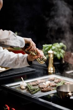 a chef preparing food on top of a stove