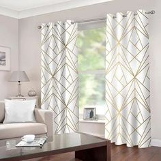 a living room with white and gold curtains