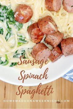 sausage and spinach spaghetti on a white plate with text overlay that reads sausage, spinach and spaghetti