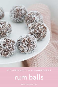 a white plate topped with powdered donuts on top of a pink towel