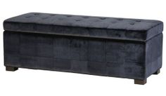 an upholstered storage bench in black velvet