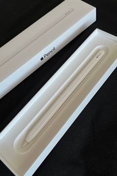 an apple pencil in its box on a black surface