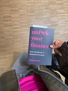 a person holding up a book in their hand with the title unlock your finance written on it