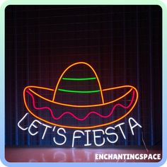 a neon sign that says let's fiesta with a sombrero on it