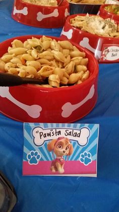 there are many different types of food on the table at this dog themed birthday party