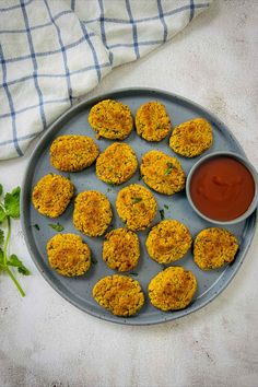 Chickpea nuggets on a grey plate served with ketchup.