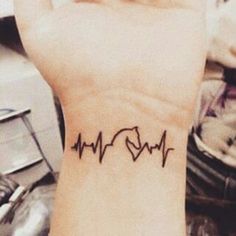 a small heartbeat tattoo on the wrist