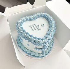 a heart shaped cake in a white box