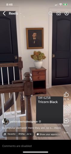 an image of a living room with black doors and white trimmings on the walls