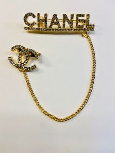 This CC brooch pin is beautiful and great quality. Alloy with Gold Plating, Gold Chain accent and rhinestones. 2 inches Across 1/2 inch Down Chain- 4 1/2 inches Down Little CC Pin- 3/4 inches Across, 1/2 inch Down Very cute! Perfect for blazer/jackets, hats, shirts and more! Luxury Silver Pins For Formal Wear, Luxury Rhinestones Brooches As Gift, Luxury Statement Brooches With Rhinestones, Luxury Rhinestone Brooches For Gift, Cheap Gold Brooches With Rhinestones, Luxury Silver Statement Pins, Luxury Statement Pins For Party, Chanel Pins, Cc Brooch