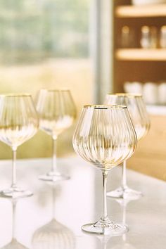 several wine glasses lined up on a table