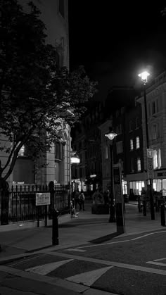 black and white photograph of city street at night