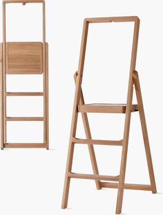 a wooden folding chair next to an empty wood stepladder on a white background