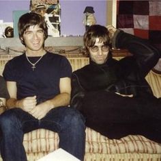 three young men sitting on top of a couch