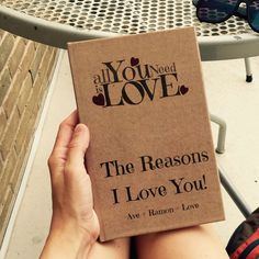 someone holding up a book that says, the reason i love you