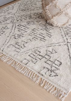 a white rug with fringes on the floor