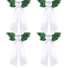 two white bows with green leaves on them