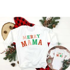 A matching duo! Merry Mama + Merry Mini - cute family matching this holiday season for moms and kids of any age! ✨Details✨ Product Options: Adult Crewneck Sweatshirt (White) - Gildan 18500 Adult Short Sleeve T-shirt (White) - Bella + Canvas 3001 Youth Short Sleeve T-shirt (White) - Bella + Canvas 3001Y Toddler Short Sleeve T-shirt (White) - Bella + Canvas 3001T Infant Longsleeve Bodysuit (White) - Rabbit Skins 4400 Infant Short Sleeve Bodysuit (White) - Rabbit Skins 4411 Please message me if you would like a different product type or color, and I will try my best to make it happen!  ✨Colors✨ ➤ Please see colors in listing photos. If you would like your design on a color that is not offered, message us and we will try to make it happen. ➤ Shirt colors may appear slightly different on differ Mama Merry, Mama And Mini, Matching Christmas Shirts, Mom And Me, Bodysuit White, Sweatshirt White, Baby's First Christmas, Mini Christmas, Christmas Mom