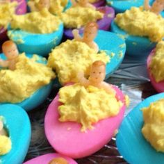 cupcakes decorated with yellow frosting and small figurines sitting on top of them