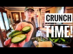 a woman holding up some cucumbers in her hand with the words crunch time