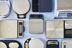 many different electronic devices are arranged on a white table top with blue and black accents