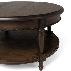 an oval coffee table with two wooden legs and a round top on the bottom shelf