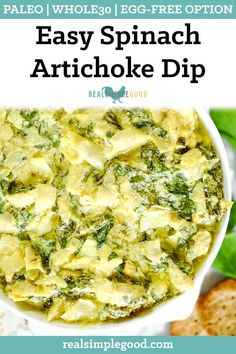 an easy spinach artichoke dip in a white bowl with bread on the side