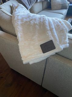 a white blanket sitting on top of a couch