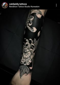 a person with a black and white tattoo on their arm