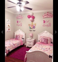 two twin beds in a girls'bedroom with pink and white decor on the walls