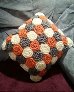 there is a crocheted pillow on the bed