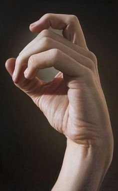 a person's hand holding something up in the air with their fingers on it