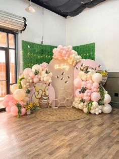 the balloon arch is decorated with pink, white and gold balloons