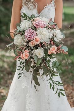 a bride holding a bouquet of flowers in her hands