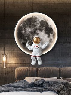 an astronaut floating in the air above a bed with a full moon on it's wall