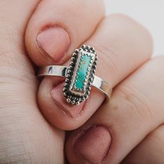 This beautiful ring features a stunning aqua blue Royston turquoise gemstone in a long rectangle shape. The sterling silver setting is adorned with delicate beaded details. This ring is a truly eye-catching piece that would make a wonderful addition to any jewelry collection. The Royston turquoise gemstone is known for its unique color and striking patterns, making it a highly sought-after stone. The aqua blue color of this particular gemstone is simply gorgeous. The long rectangle shape is also Rectangular Turquoise Gemstone Ring, Handmade Turquoise Rectangular Rings, Silver Rectangular Turquoise Gemstone Ring, Rectangular Turquoise Sterling Silver Ring, Bohemian Sterling Silver Ring With Rectangular Shape, Rectangular Turquoise Ring Gift, Handmade Silver Turquoise Ring With Rectangular Shape, Handmade Silver Rectangular Turquoise Ring, Handmade Rectangular Silver Turquoise Ring