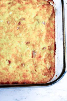 a casserole dish with meat and cheese in it on a white counter top