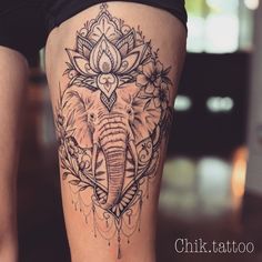 an elephant tattoo on the side of a woman's leg