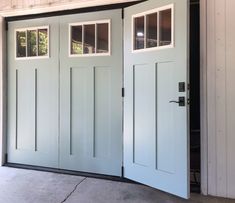 a garage door with two windows on each side