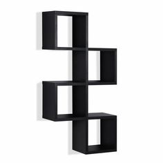 a black shelf with three cubes on the bottom and one in the middle, against a white wall